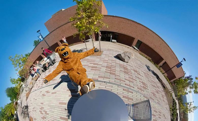 nittany lion mascot sitting at table on patio