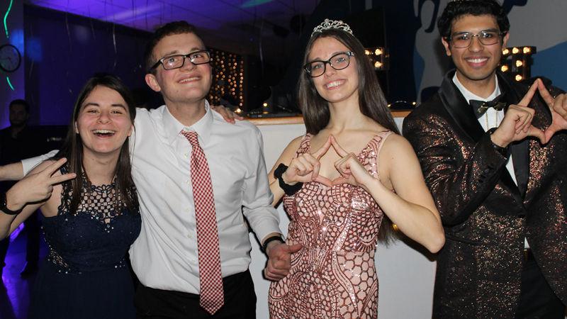 four students pose for photo at THON fundraiser