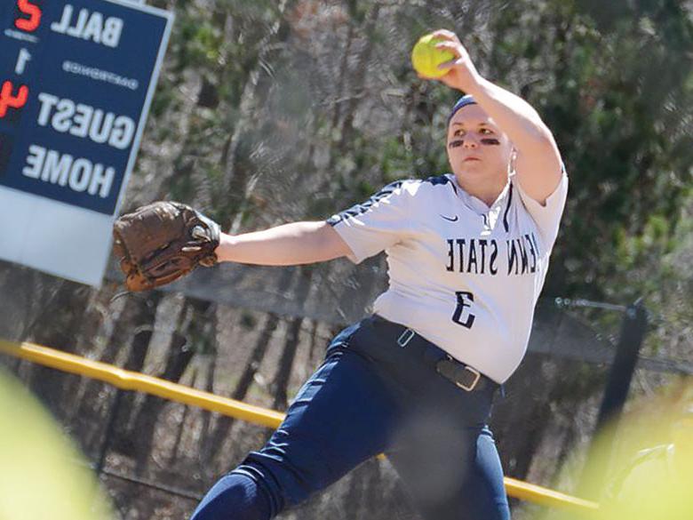 Penn State softball player winds up to pitch the ball
