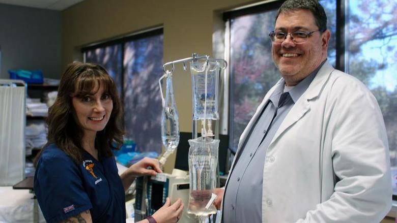 Mike Evans and Darla Lattimer pose for a photo in Penn State Scranton's nursing sim lab